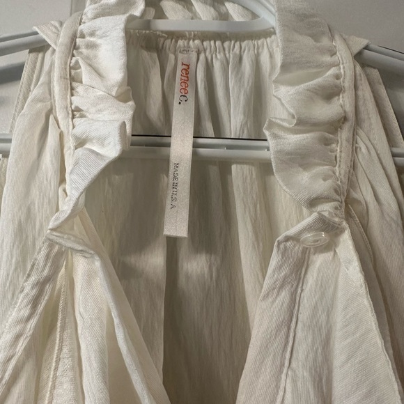 Renee C white asymmetrical hem top. Beautifully detailed with ruffle and bow. - Picture 1 of 3